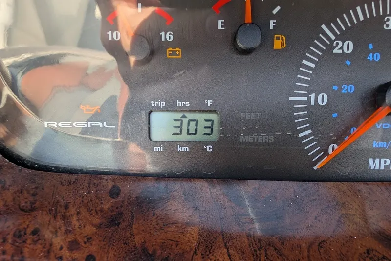 Slide: The Image of Dashboard of a 2002 Regal 2450 LSC showing 303 hours on digital display. - 33