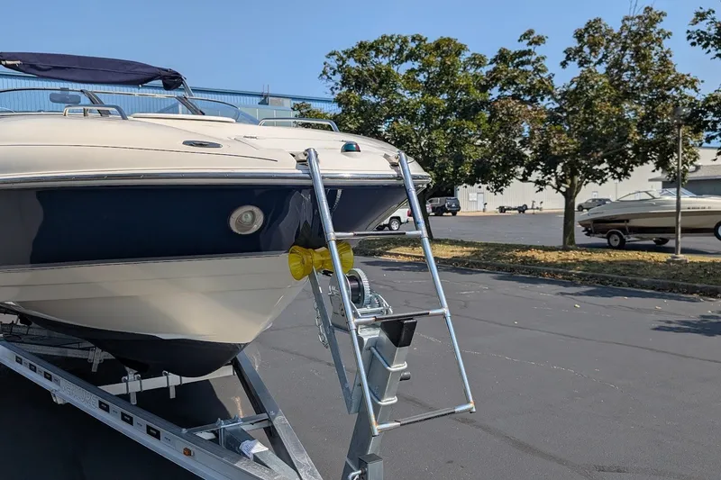 Slide: The Image of 2002 Regal 2450 LSC boat on trailer in parking lot, sunny day. - 7