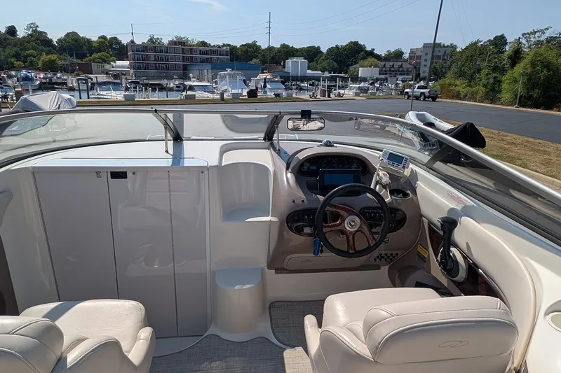 Slide: The Image of Interior view of a 2002 Regal 2450 LSC boat cockpit with steering wheel and controls. - 28
