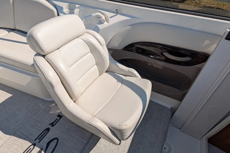 Slide: The Image of 2002 Regal 2450 LSC boat interior with white leather seating and cup holder. - 27