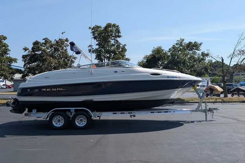 Slide: The Image of 2002 Regal 2450 LSC boat on trailer, parked outdoors on a sunny day. - 5