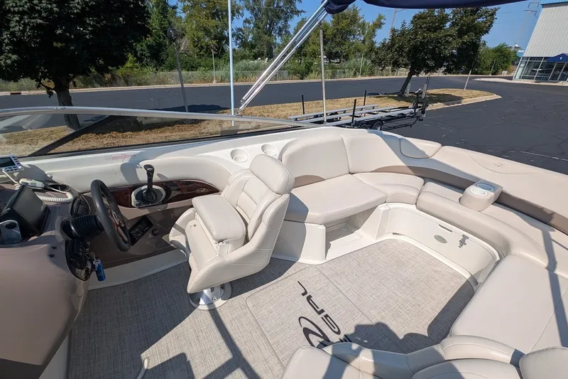 Slide: The Image of Interior of a 2002 Regal 2450 LSC boat with beige seating and steering console. - 29