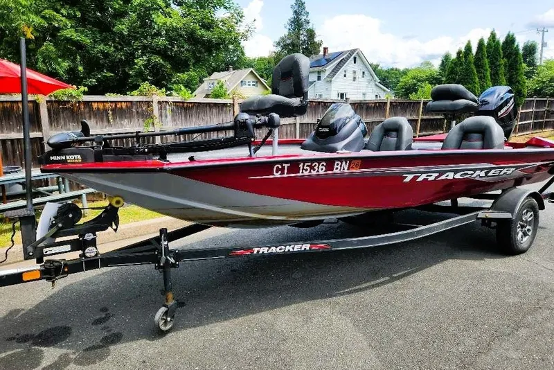 The Image of 2022 Tracker Pro Team 175 TXW Tournament Edition boat on trailer, parked outdoors. - 0