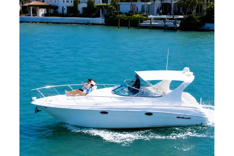 The Image of 2001 Wellcraft 3300 Martinique cruising on clear blue water. - 0