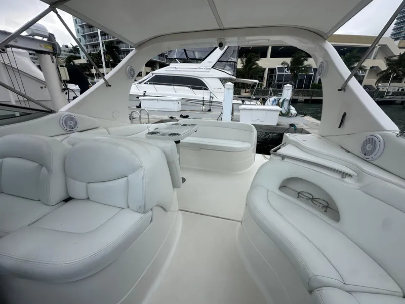 Slide: The Image of 2001 Wellcraft 3300 Martinique yacht interior with white seating and marina view. - 23