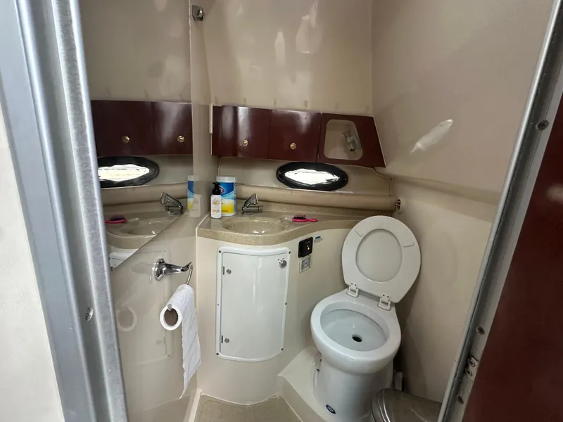 Slide: The Image of 2001 Wellcraft 3300 Martinique bathroom with sink, toilet, and storage cabinets. - 22