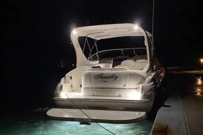 Slide: The Image of 2001 Wellcraft 3300 Martinique yacht docked at night, illuminated with underwater lights. - 29