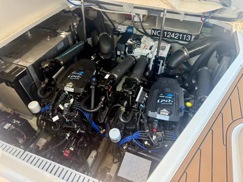 Slide: The Image of Engine compartment of the 2009 Sea Ray Sundancer 310 with dual engines and technical components. - 22