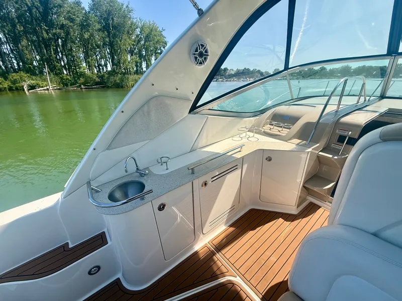 Slide: The Image of The image shows the cockpit of a 2009 Sea Ray Sundancer 310 with elegant features. - 3