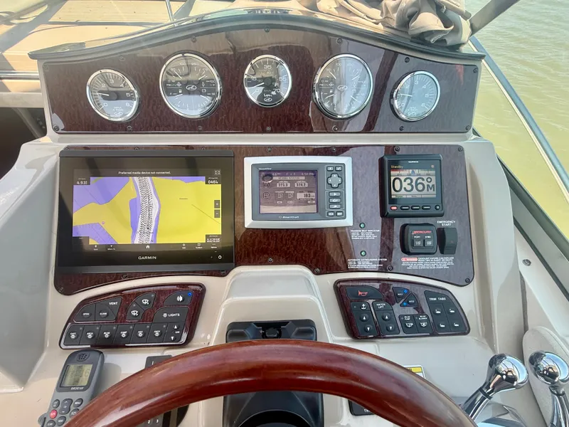 Slide: The Image of The dashboard of a 2009 Sea Ray Sundancer 310 with navigation system and instruments. - 10