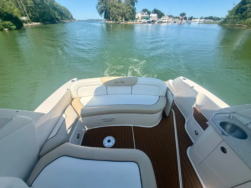 Slide: The Image of The image shows the stern of a 2009 Sea Ray Sundancer 310 boat on calm waters. - 6