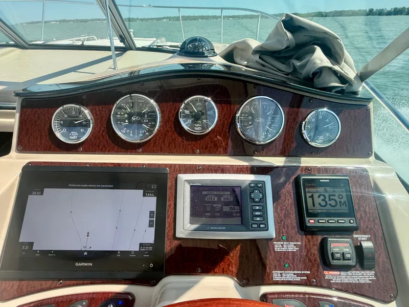 Slide: The Image of The cockpit of a 2009 Sea Ray Sundancer 310 with modern navigation instruments. - 12