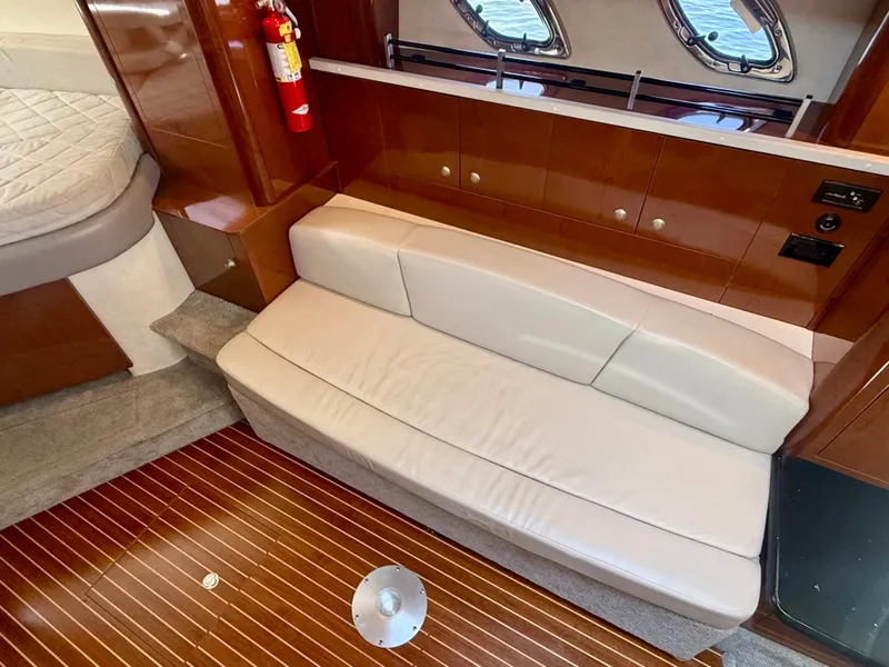 Slide: The Image of Interior of a 2009 Sea Ray Sundancer 310 with cream sofa and wooden flooring. - 17
