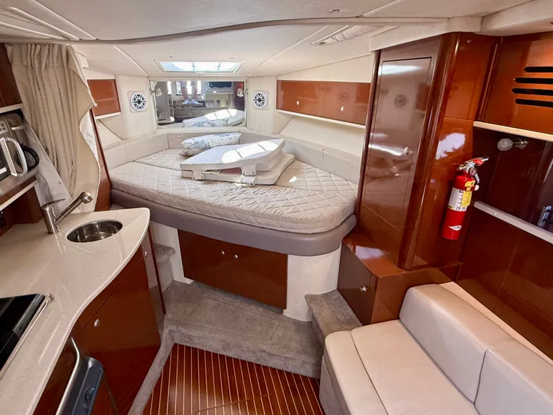 Slide: The Image of Interior of a 2009 Sea Ray Sundancer 310 with cozy bed and kitchenette. - 13