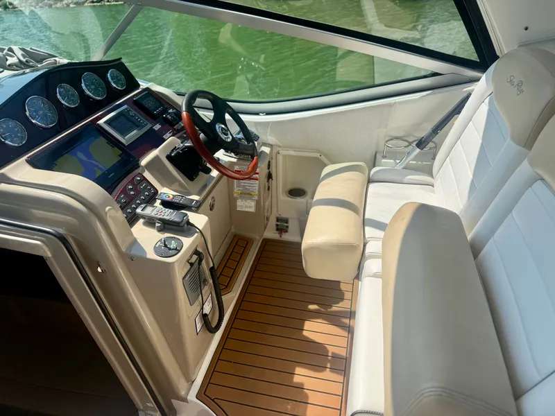 Slide: The Image of The cockpit of a 2009 Sea Ray Sundancer 310 with modern instruments and comfortable seating. - 7