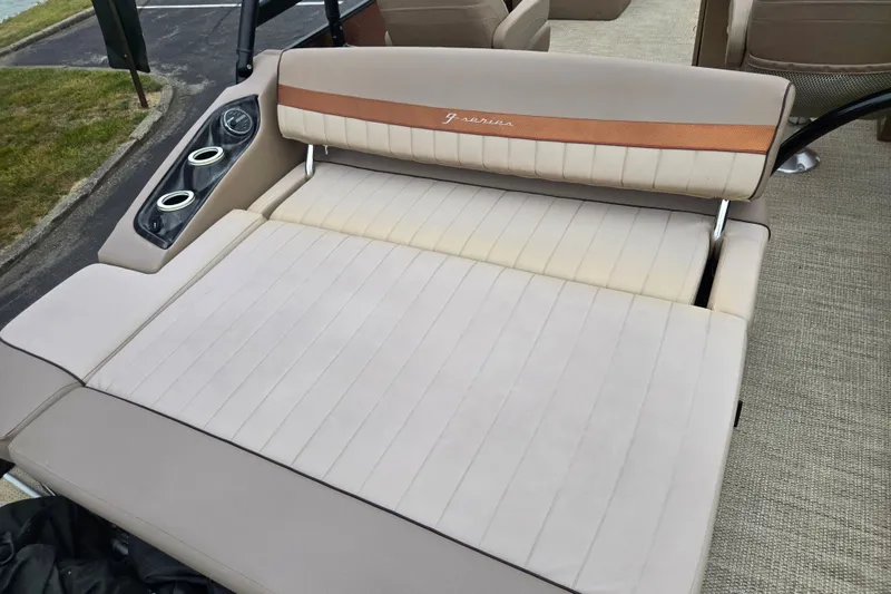 Slide: The Image of 2017 Bennington G 23 GSBA boat interior with beige seating and cup holders. - 19