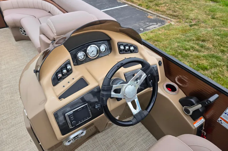 Slide: The Image of 2017 Bennington G 23 GSBA boat dashboard with steering wheel and control panel. - 22