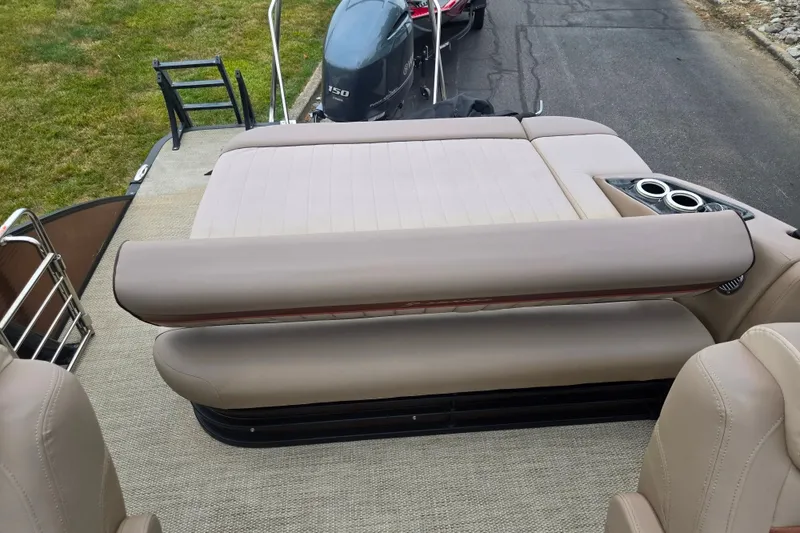 Slide: The Image of 2017 Bennington G 23 GSBA boat interior with beige seating and cup holders. - 15