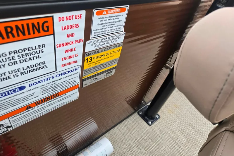 Slide: The Image of Warning labels on 2017 Bennington G 23 GSBA boat, highlighting safety and capacity limits. - 14