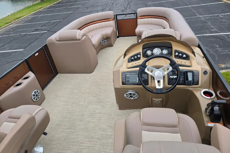 Slide: The Image of 2017 Bennington G 23 GSBA pontoon boat interior with beige seating and modern dashboard. - 21