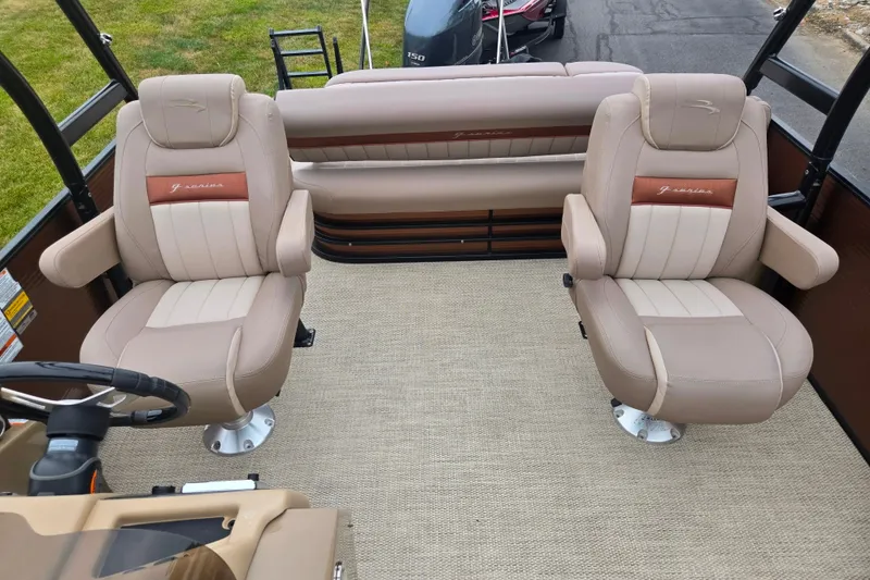 Slide: The Image of 2017 Bennington G 23 GSBA boat interior with beige captain chairs and carpeted flooring. - 13