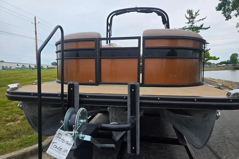 Slide: The Image of 2017 Bennington G 23 GSBA pontoon boat on trailer, lakeside view. - 6