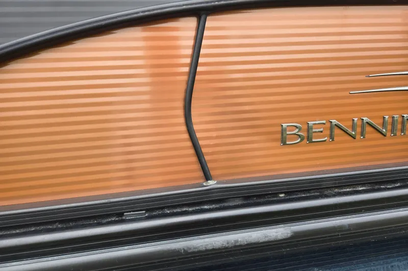 Slide: The Image of 2017 Bennington G 23 GSBA boat with orange paneling and visible branding. - 23