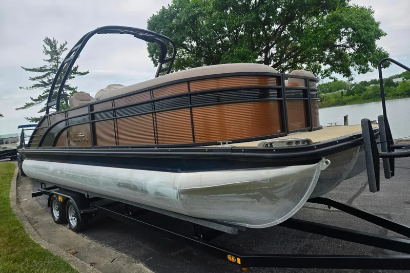 Slide: The Image of 2017 Bennington G 23 GSBA pontoon boat on trailer by a lakeside. - 8