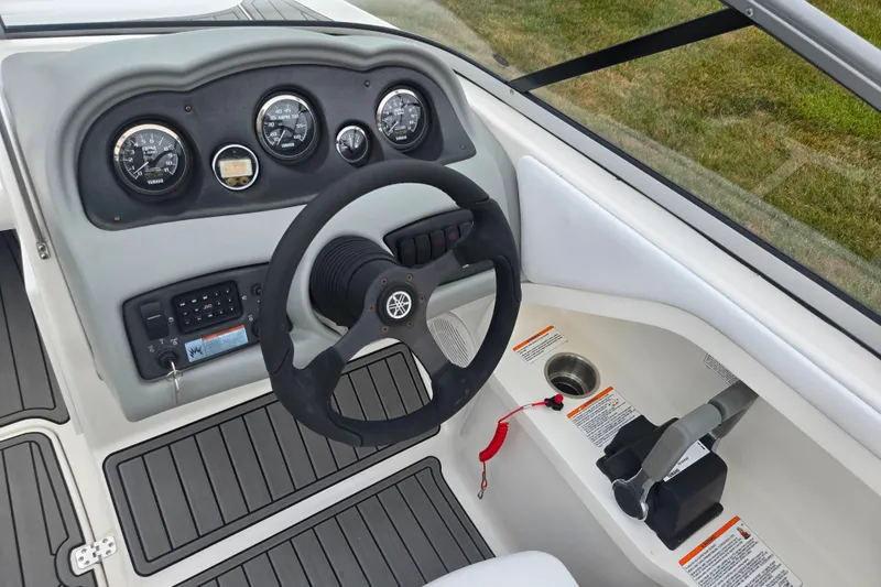 Slide: The Image of 2005 Yamaha Boats SX230 dashboard with steering wheel and control panel. - 11