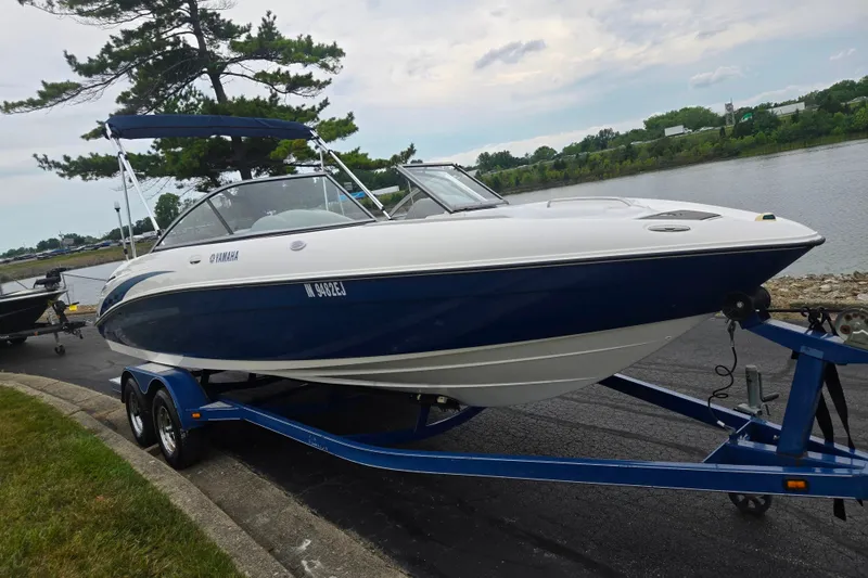 Slide: The Image of 2005 Yamaha Boats SX230 on trailer by a lakeside, ready for adventure. - 8