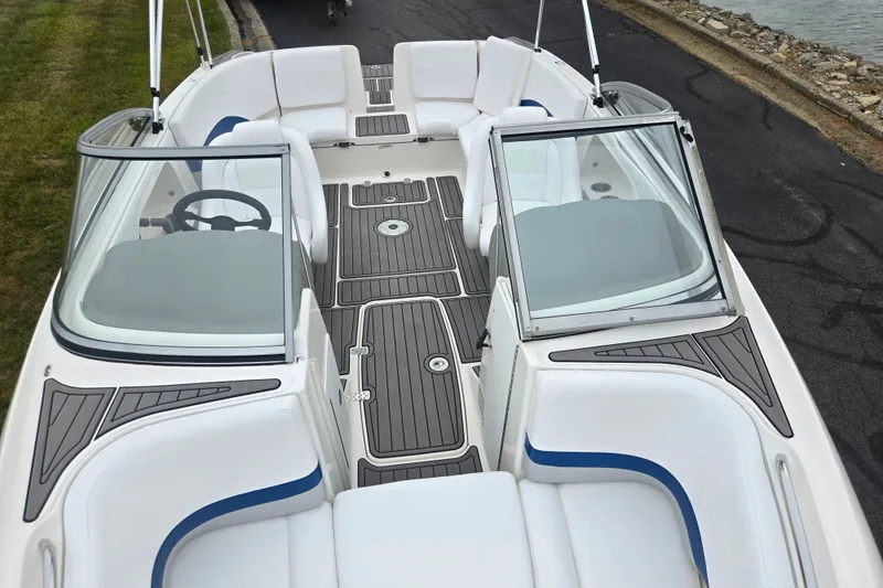 Slide: The Image of 2005 Yamaha Boats SX230 interior with sleek seating and modern dashboard design. - 19