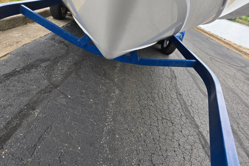 Slide: The Image of 2005 Yamaha Boats SX230 on blue trailer near water. - 7