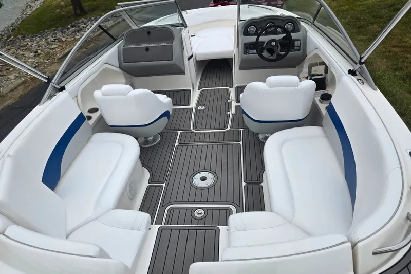 Slide: The Image of 2005 Yamaha Boats SX230 interior with white seating and sleek dashboard design. - 9