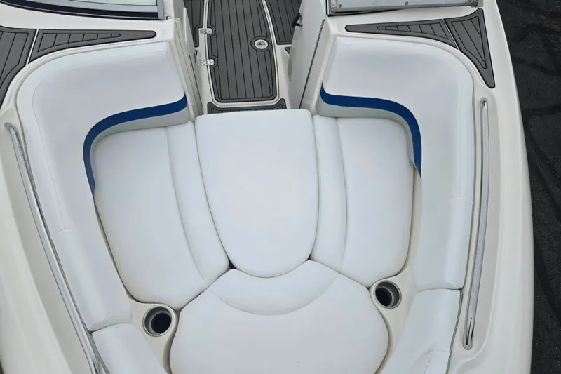 Slide: The Image of 2005 Yamaha Boats SX230 interior seating with white cushions and blue accents. - 18