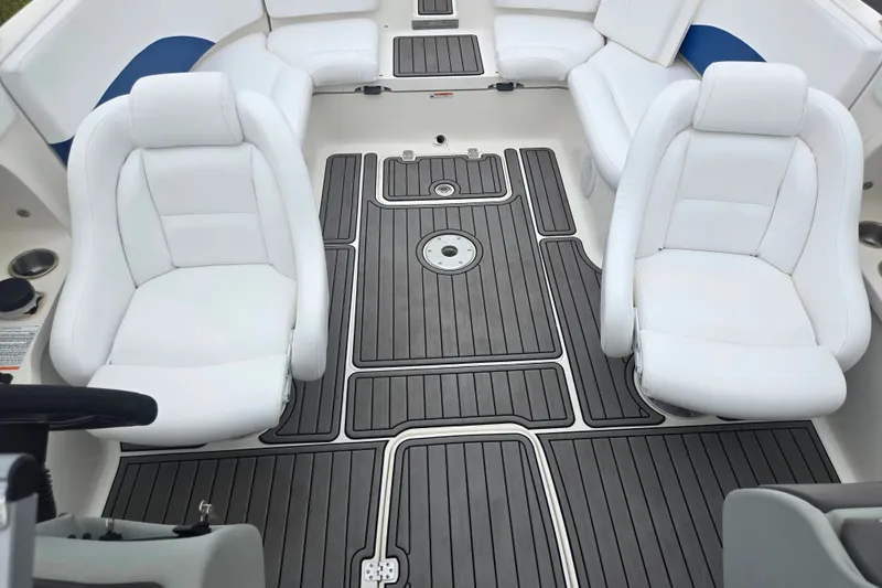 Slide: The Image of 2005 Yamaha Boats SX230 interior with white seating and sleek black flooring. - 20