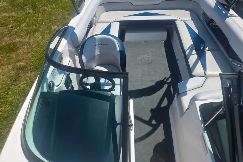 Slide: The Image of 2012 Moomba Mojo 2.5 boat interior with seating and steering wheel, viewed from above. - 19