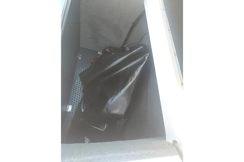 Slide: The Image of 2012 Moomba Mojo 2.5 interior storage compartment with black bag. - 24