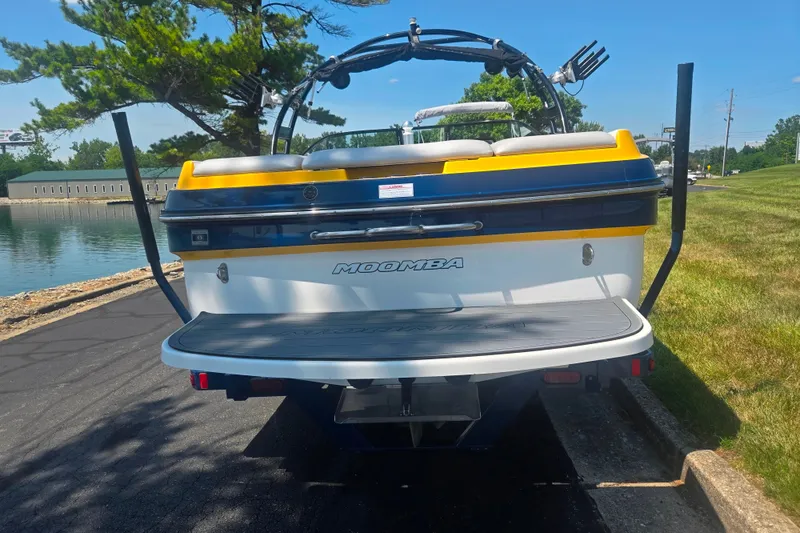 Slide: The Image of 2012 Moomba Mojo 2.5 boat parked near a lake on a sunny day. - 2