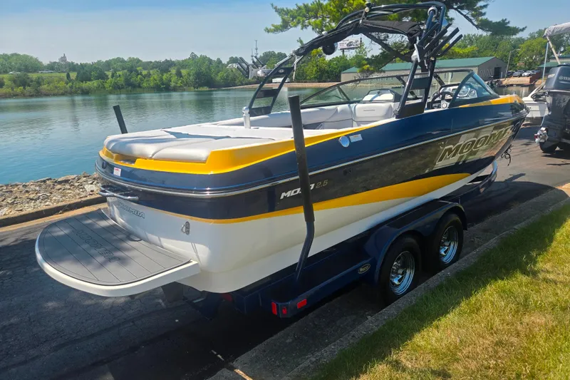 Slide: The Image of 2012 Moomba Mojo 2.5 boat on trailer by a scenic lake. - 1