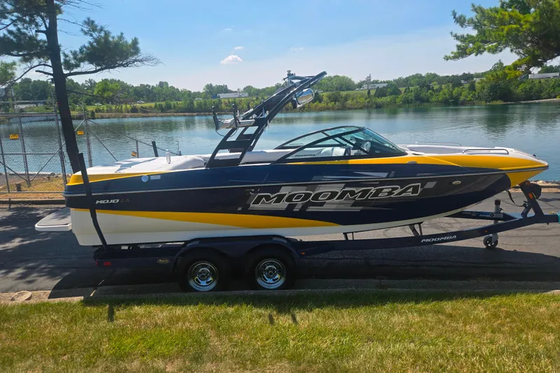 Slide: The Image of 2012 Moomba Mojo 2.5 boat on trailer by a scenic lakeside. - 9