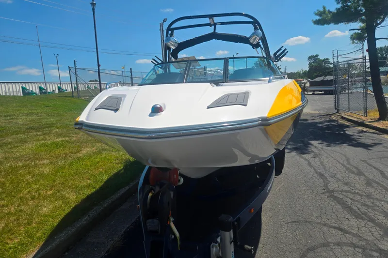 Slide: The Image of 2012 Moomba Mojo 2.5 boat on trailer, parked outdoors under blue sky. - 6