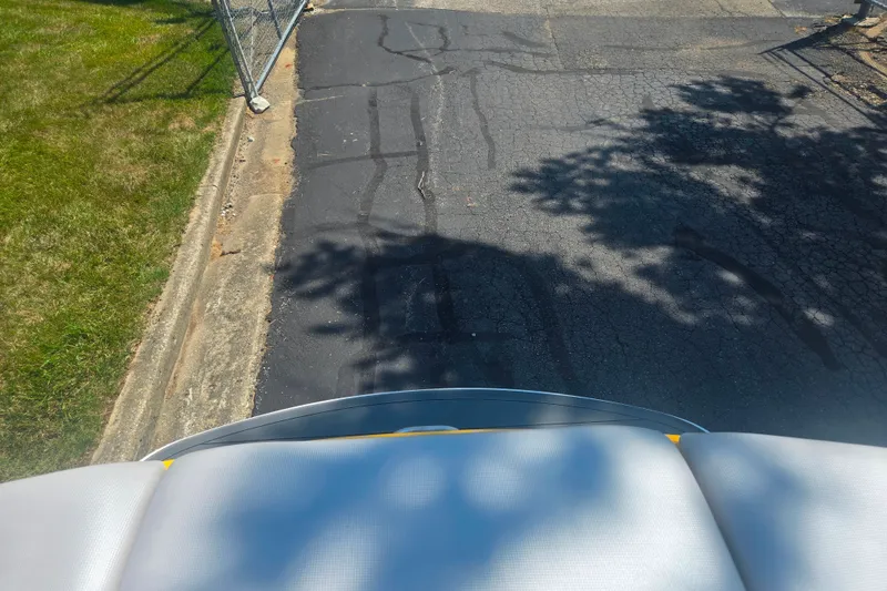 Slide: The Image of 2012 Moomba Mojo 2.5 boat on cracked asphalt near grass and fence. - 22