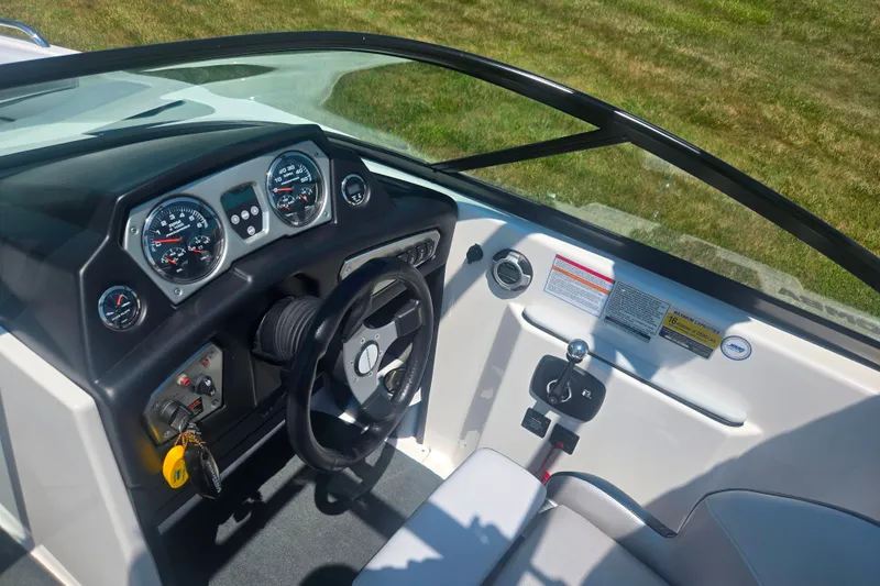Slide: The Image of 2012 Moomba Mojo 2.5 boat dashboard with steering wheel and control panel. - 14