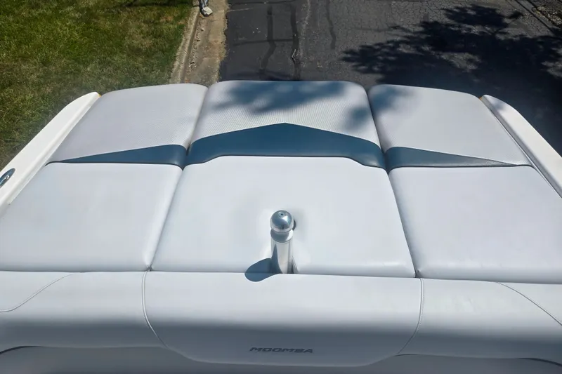 Slide: The Image of 2012 Moomba Mojo 2.5 boat with sleek, cushioned deck and polished metal fixture. - 21