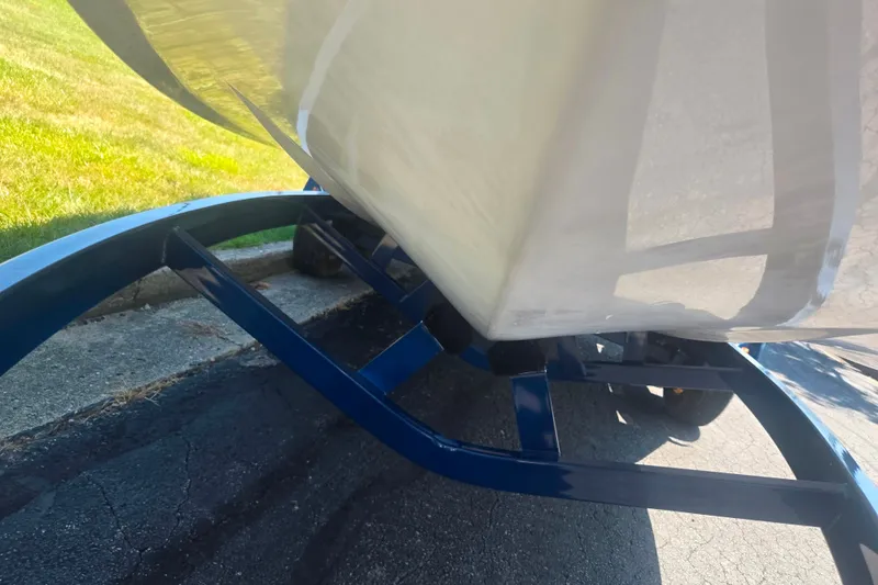 Slide: The Image of 2012 Moomba Mojo 2.5 boat on blue trailer, parked on asphalt near grass. - 7