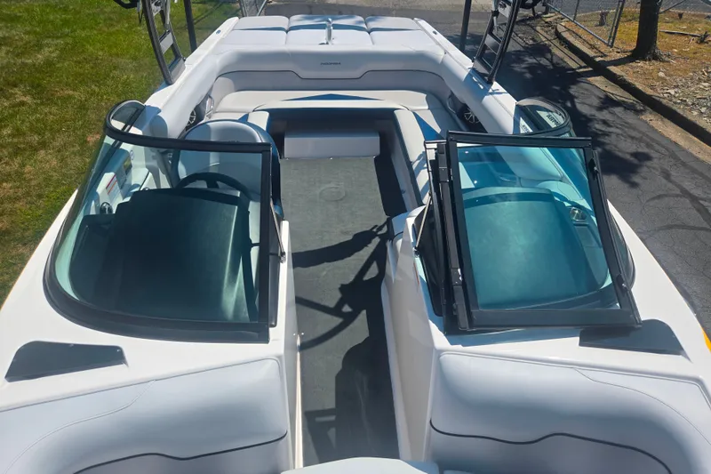 Slide: The Image of 2012 Moomba Mojo 2.5 boat interior with open windshield and seating area. - 18