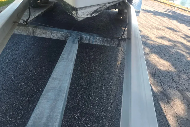 Slide: The Image of Trailer for 2013 Hurricane SunDeck Sport 188 OB boat on asphalt surface. - 7