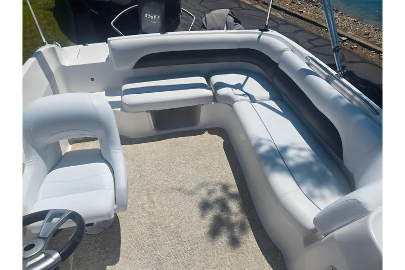 Slide: The Image of 2013 Hurricane SunDeck Sport 188 OB boat interior with white seating and steering wheel. - 14