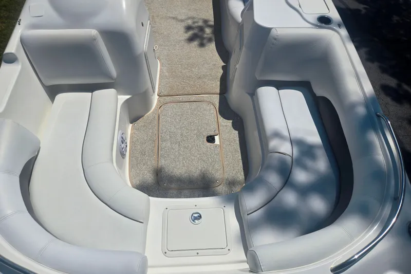 Slide: The Image of 2013 Hurricane SunDeck Sport 188 OB boat interior with white seating and carpeted floor. - 10