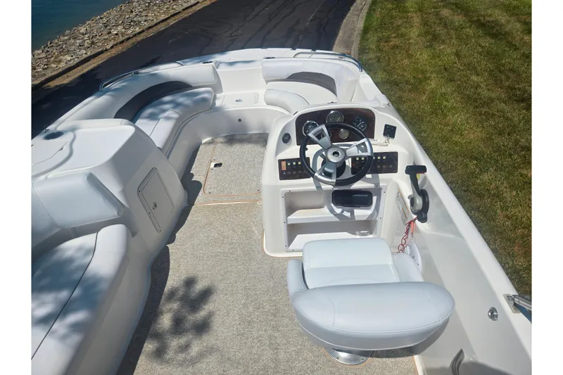 Slide: The Image of 2013 Hurricane SunDeck Sport 188 OB boat interior with steering wheel and seating. - 17